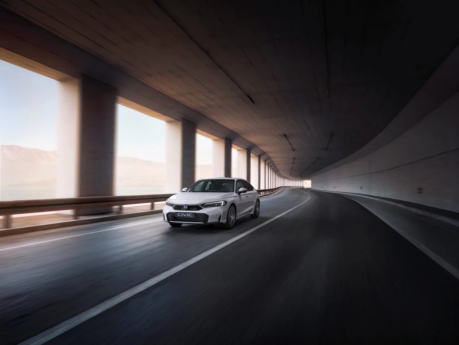 Honda Civic albă, în mișcare, printr-un tunel rutier