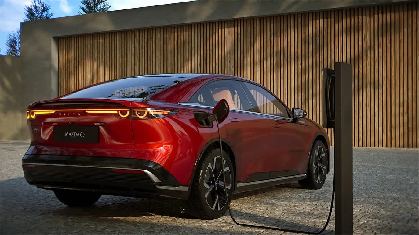 Mazda 6e roșie conectată la o stație de încărcare